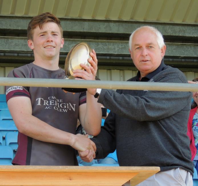 Crymych skipper Ifan Phillips receives the league championship cup from Gordon Eynon